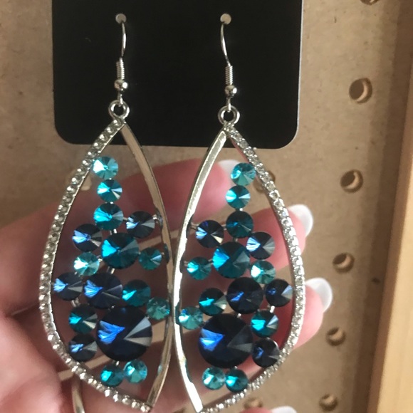 Asymmetrical earrings w/numerous & aqua stones.